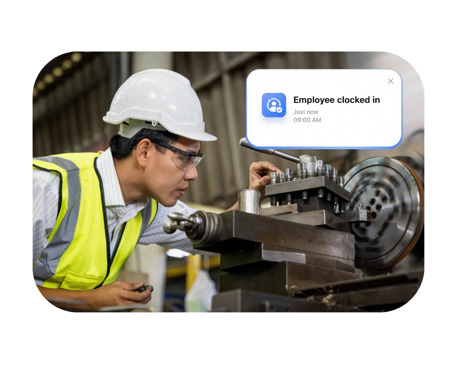 Manufacturing worker clocking in using Computime time and attendance software on the factory floor